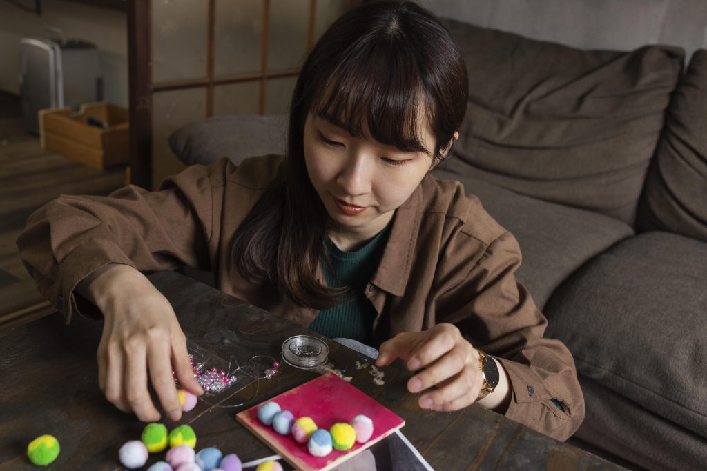 Person sorting colorful beads during a hands-on therapy activity