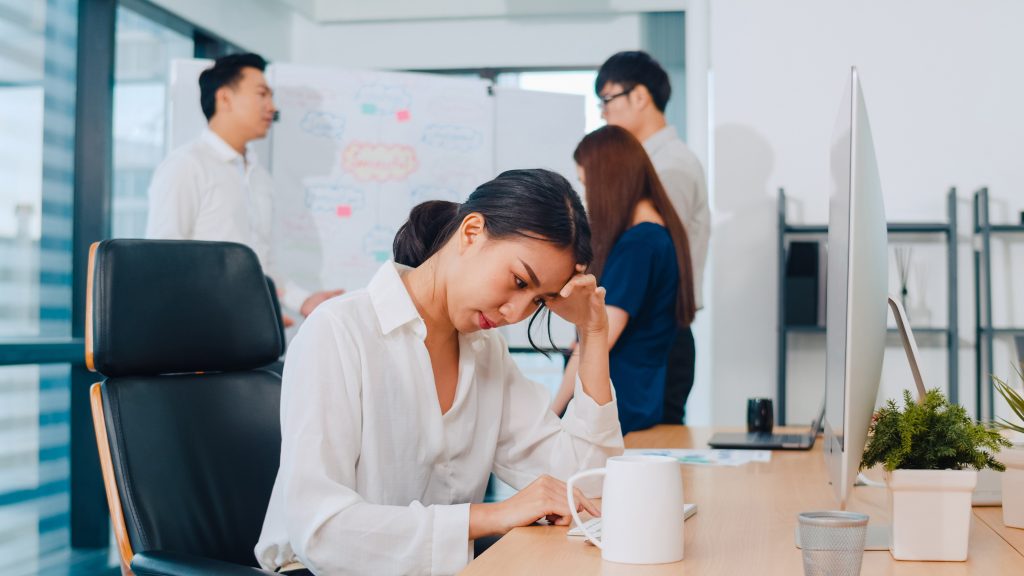 Woman looking stressed while working at a desk